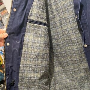 Men’s heavy work coat fits more like a large.